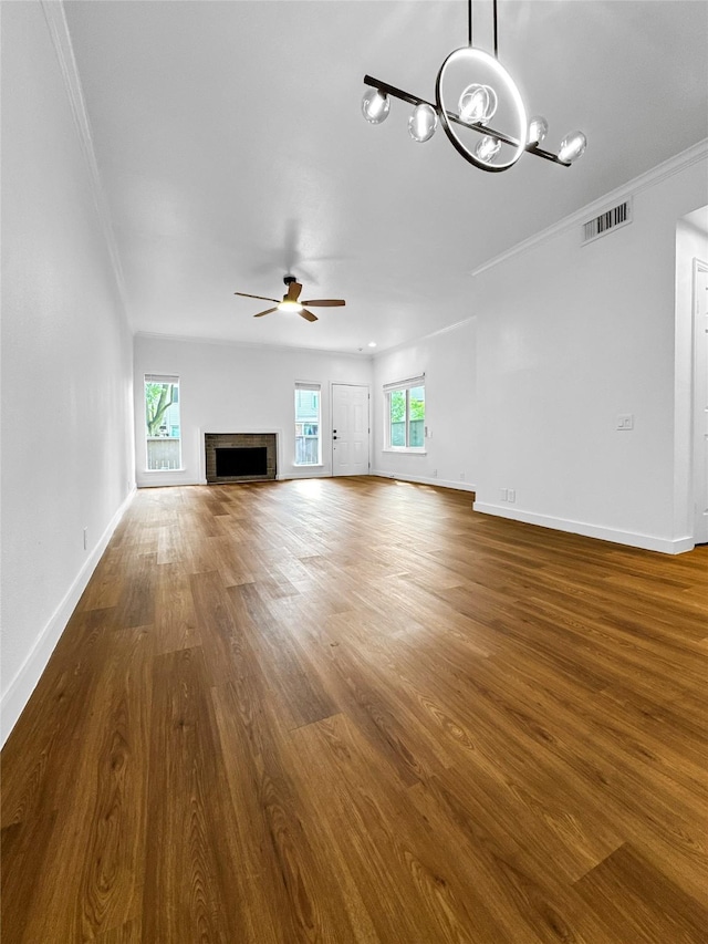 11731 Lakeside Place Dr, Houston, TX 77077 - unfurnished living room with ornamental molding, ceiling fan, a chandelier, wood finished floors, and baseboards