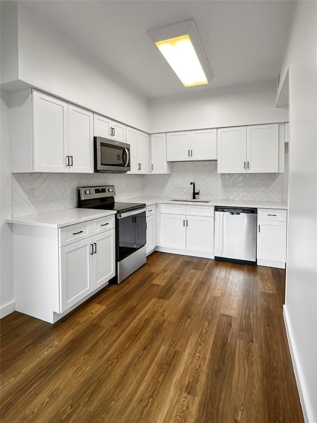 11731 Lakeside Place Dr, Houston, TX 77077 - kitchen featuring appliances with stainless steel finishes, a sink, light countertops, tasteful backsplash, and white cabinets
