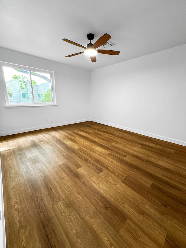 11731 Lakeside Place Dr, Houston, TX 77077 - empty room with wood finished floors, ceiling fan, and baseboards