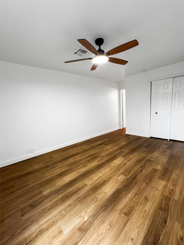 11731 Lakeside Place Dr, Houston, TX 77077 - unfurnished bedroom with baseboards, dark wood-style floors, a closet, and a ceiling fan