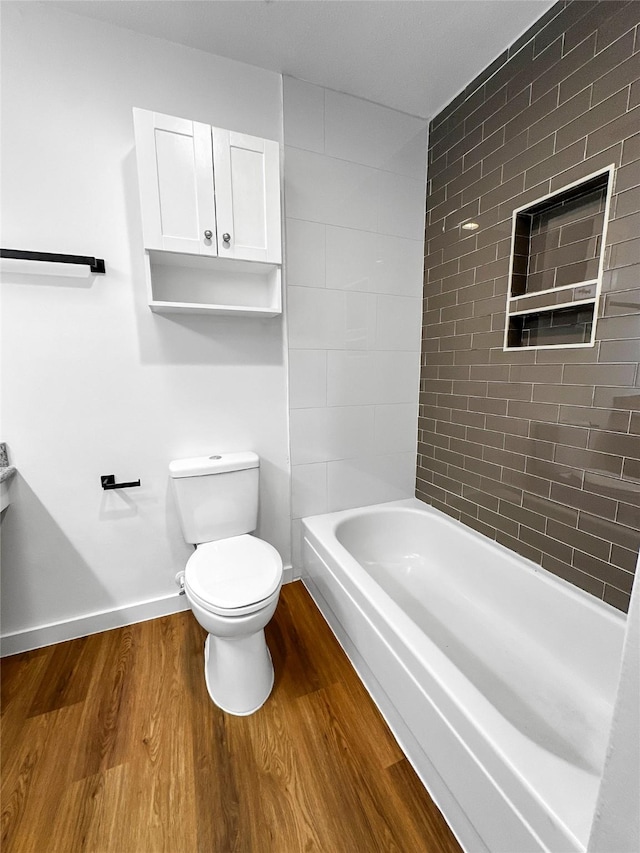 11731 Lakeside Place Dr, Houston, TX 77077 - bathroom with wood finished floors, a bathtub, toilet, and baseboards