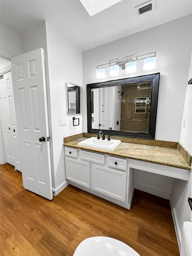 11731 Lakeside Place Dr, Houston, TX 77077 - full bathroom featuring a tile shower, wood finished floors, vanity, and baseboards