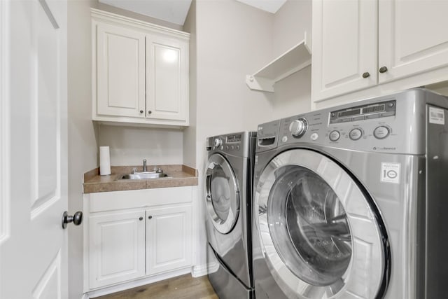 18024 Cindy Ln, Conroe, TX 77302 - laundry room featuring washing machine and clothes dryer and cabinet space