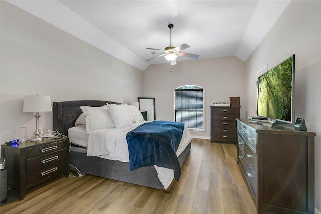 18024 Cindy Ln, Conroe, TX 77302 - bedroom featuring light wood-type flooring, vaulted ceiling, and a ceiling fan