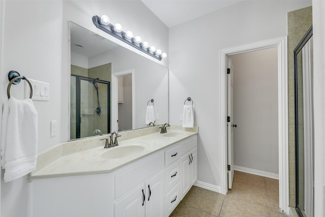 18024 Cindy Ln, Conroe, TX 77302 - bathroom with double vanity, tile patterned flooring, a shower stall, and baseboards