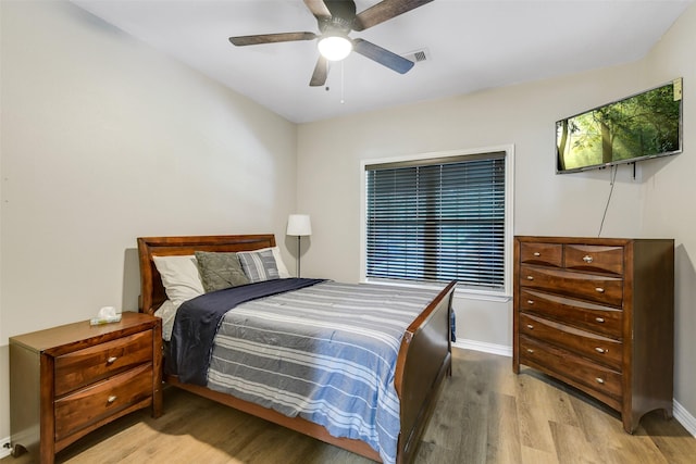 18024 Cindy Ln, Conroe, TX 77302 - bedroom with wood finished floors, baseboards, and ceiling fan