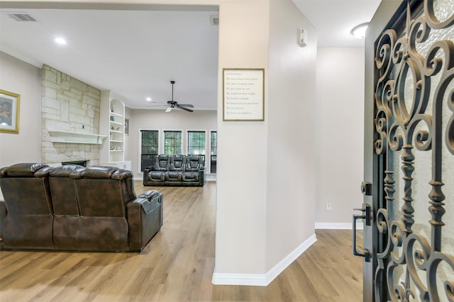 18024 Cindy Ln, Conroe, TX 77302 - living room featuring light wood-style floors, a ceiling fan, baseboards, a fireplace, and recessed lighting