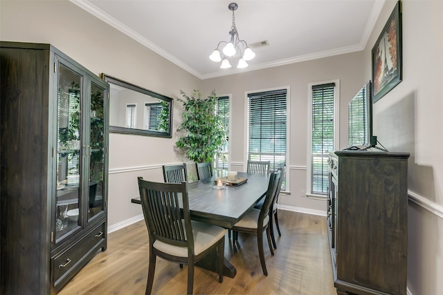 18024 Cindy Ln, Conroe, TX 77302 - dining area featuring light wood-style floors, a chandelier, ornamental molding, and baseboards