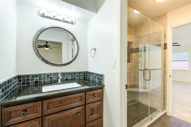1715 Cobblestone Ct, Richmond, TX 77406 - full bathroom with a ceiling fan, vanity, a shower stall, tile patterned floors, and tasteful backsplash