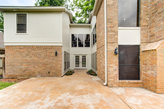 1715 Cobblestone Ct, Richmond, TX 77406 - rear view of house featuring french doors, brick siding, and a patio area