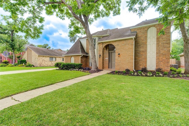 1715 Cobblestone Ct, Richmond, TX 77406 - view of front of house with a front yard, brick siding, and roof with shingles