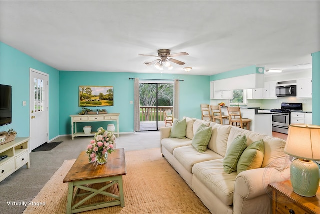 3225 N Jackson St, Santa Fe, TX 77517 - living area featuring ceiling fan, light carpet, healthy amount of natural light, and baseboards