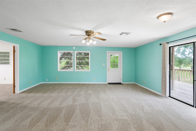 3225 N Jackson St, Santa Fe, TX 77517 - carpeted spare room featuring a textured ceiling, ceiling fan, and baseboards