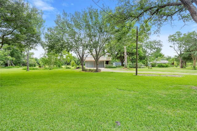 3225 N Jackson St, Santa Fe, TX 77517 - view of grassy yard with dirt driveway and a garage