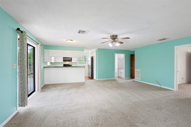 3225 N Jackson St, Santa Fe, TX 77517 - unfurnished living room with light carpet, baseboards, and a ceiling fan