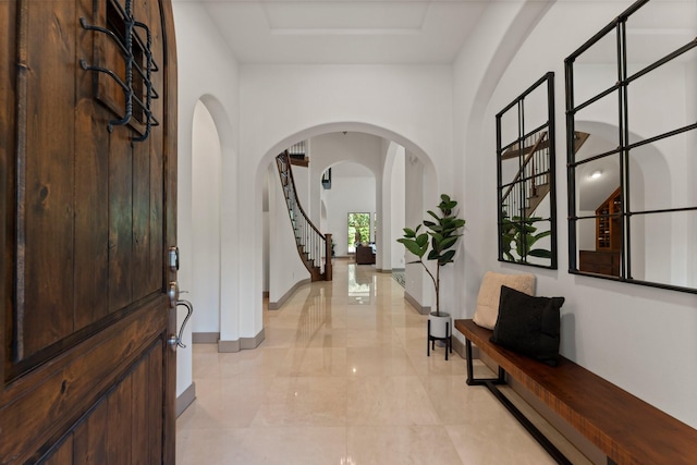 82 Valera Ridge Dr, Spring, TX 77389 - foyer entrance with arched walkways, light marble finish floors, baseboards, and stairs