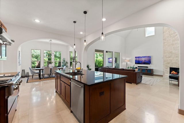 82 Valera Ridge Dr, Spring, TX 77389 - kitchen featuring a sink, dark countertops, appliances with stainless steel finishes, arched walkways, and recessed lighting