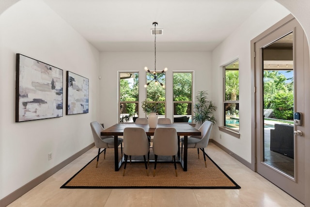 82 Valera Ridge Dr, Spring, TX 77389 - dining room with a chandelier, arched walkways, baseboards, and light tile patterned flooring