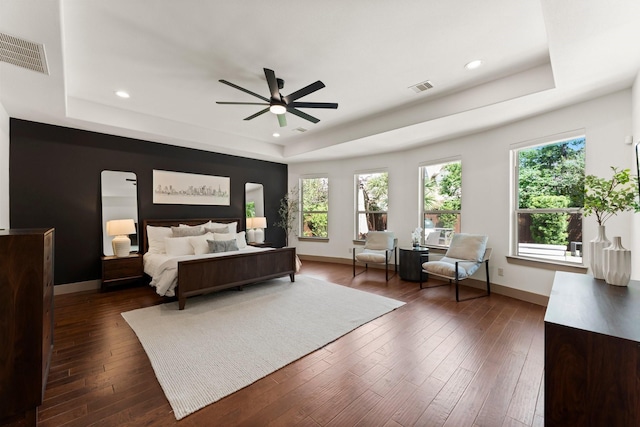 82 Valera Ridge Dr, Spring, TX 77389 - bedroom featuring a tray ceiling, multiple windows, recessed lighting, and dark wood-style flooring