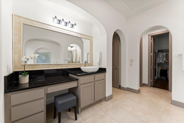 82 Valera Ridge Dr, Spring, TX 77389 - bathroom featuring vanity, tile patterned flooring, baseboards, and tasteful backsplash