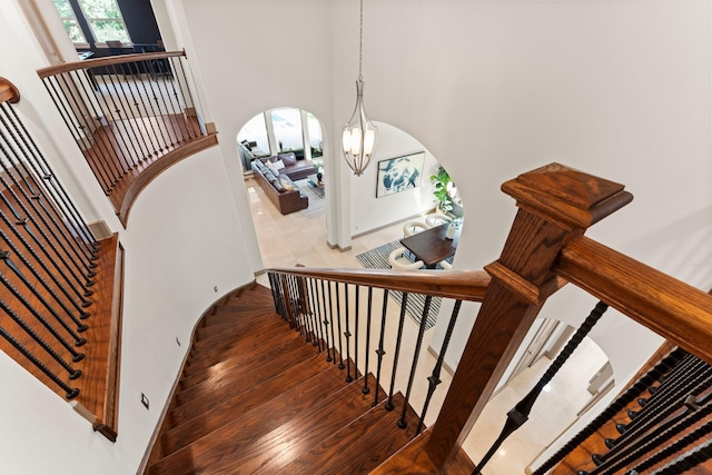 82 Valera Ridge Dr, Spring, TX 77389 - stairway featuring arched walkways, wood finished floors, and a high ceiling
