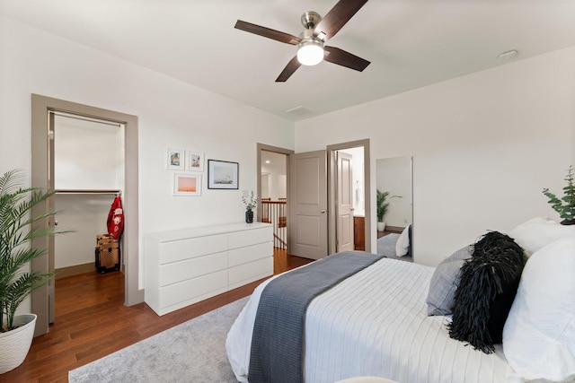 82 Valera Ridge Dr, Spring, TX 77389 - bedroom with wood finished floors, a spacious closet, and a ceiling fan