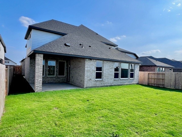 21910 Wycombe Terrace Way, Cypress, TX 77433 - back of property featuring brick siding, a patio, and a shingled roof