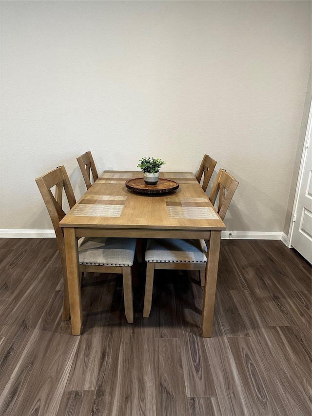 13556 Bowfin Dr, Conroe, TX 77384 - dining room featuring baseboards and wood finished floors