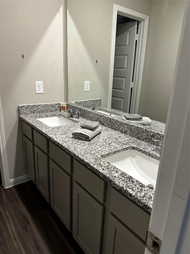 13556 Bowfin Dr, Conroe, TX 77384 - bathroom with double vanity, wood finished floors, and baseboards
