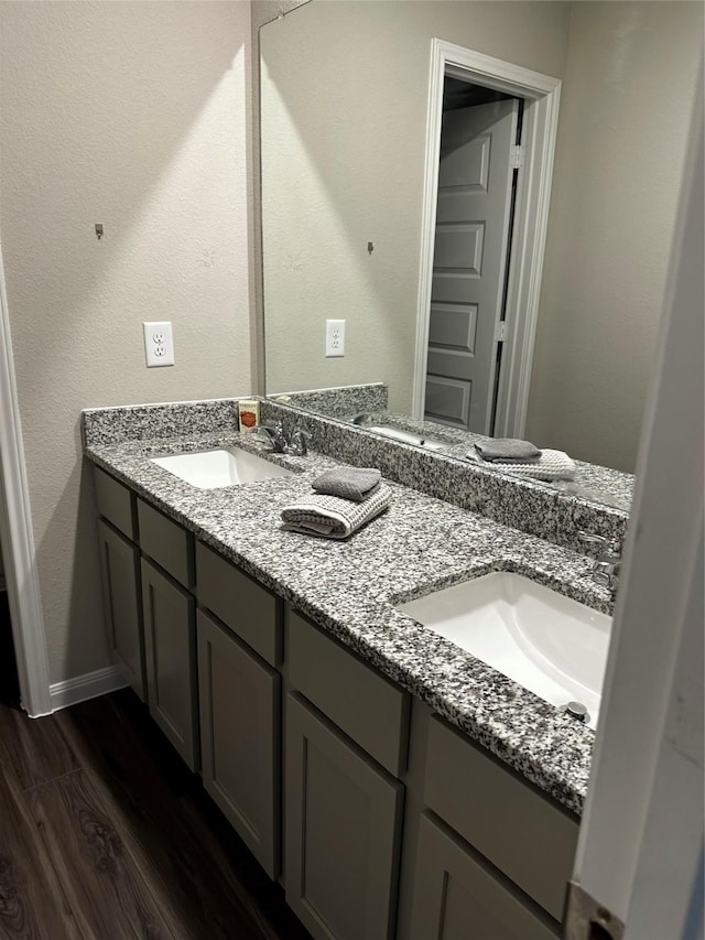 13556 Bowfin Dr, Conroe, TX 77384 - full bath with double vanity, wood finished floors, and baseboards
