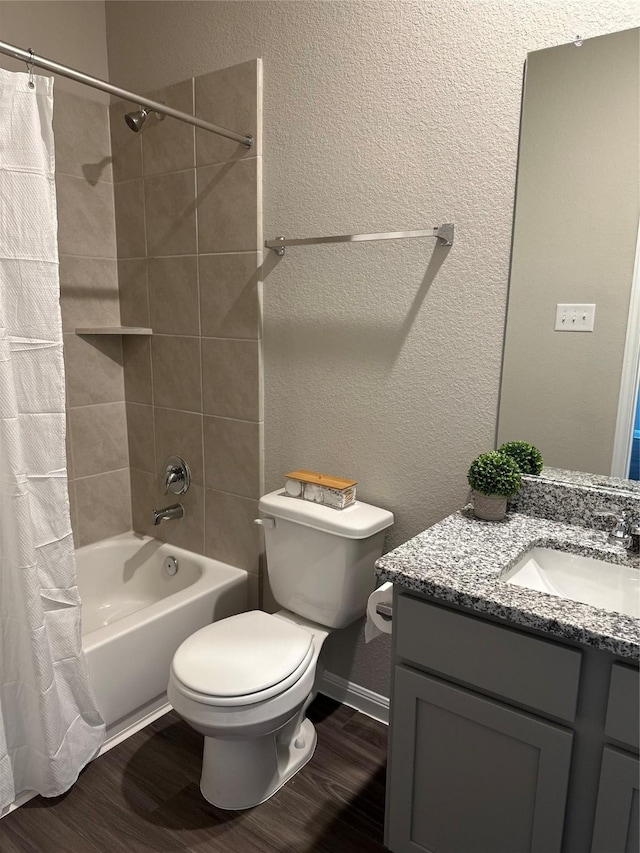 13556 Bowfin Dr, Conroe, TX 77384 - full bathroom featuring vanity, toilet, wood finished floors, shower / tub combo, and a textured wall