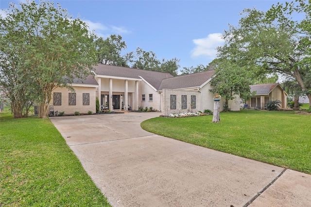 8219 Magnolia Glen Dr, Humble, TX 77346 - view of front of home with driveway, a front lawn, brick siding, and a shingled roof