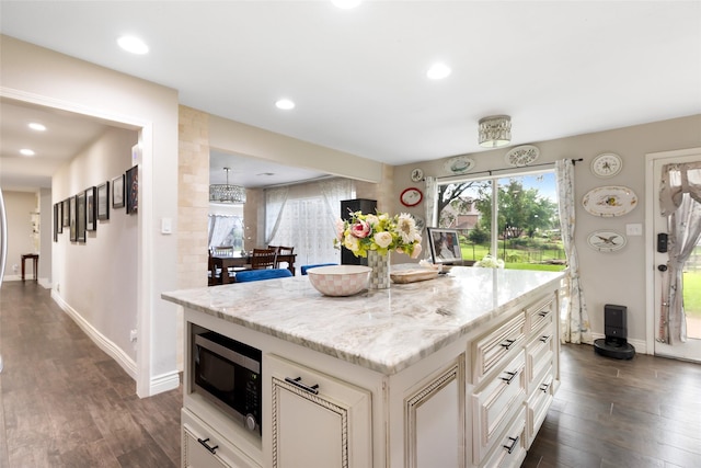 8219 Magnolia Glen Dr, Humble, TX 77346 - kitchen featuring stainless steel microwave, dark wood-style flooring, baseboards, light stone countertops, and recessed lighting