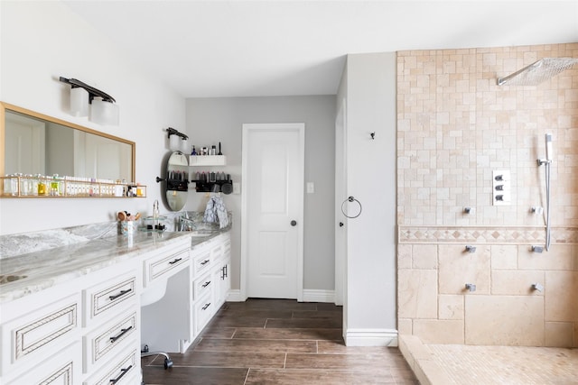8219 Magnolia Glen Dr, Humble, TX 77346 - bathroom with a walk in shower, vanity, wood finish floors, and baseboards