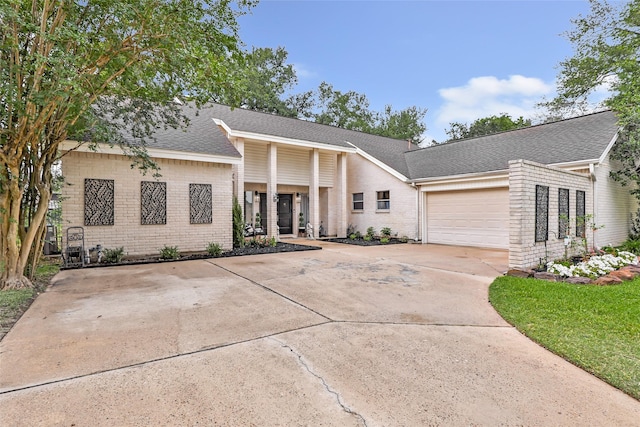 8219 Magnolia Glen Dr, Humble, TX 77346 - mid-century modern home with brick siding, driveway, a shingled roof, and an attached garage