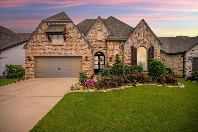 23619 Bottlebrush Terrace Trl, Katy, TX 77493 - view of front of home featuring brick siding, a shingled roof, concrete driveway, a front lawn, and a garage