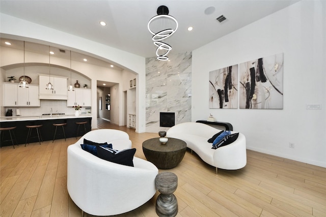 23619 Bottlebrush Terrace Trl, Katy, TX 77493 - living area featuring light wood-style floors, recessed lighting, baseboards, and arched walkways