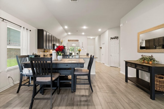 15111 Raffia Leaves Way, Houston, TX 77090 - dining area with light wood-type flooring, baseboards, and lofted ceiling