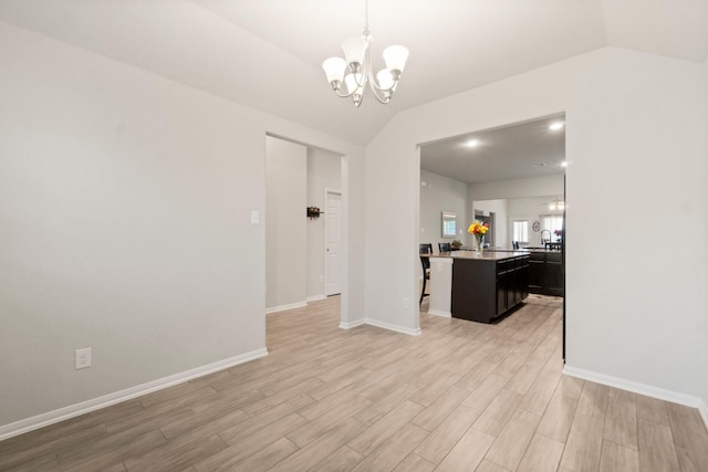 15111 Raffia Leaves Way, Houston, TX 77090 - unfurnished living room with a chandelier, light wood-type flooring, lofted ceiling, and baseboards