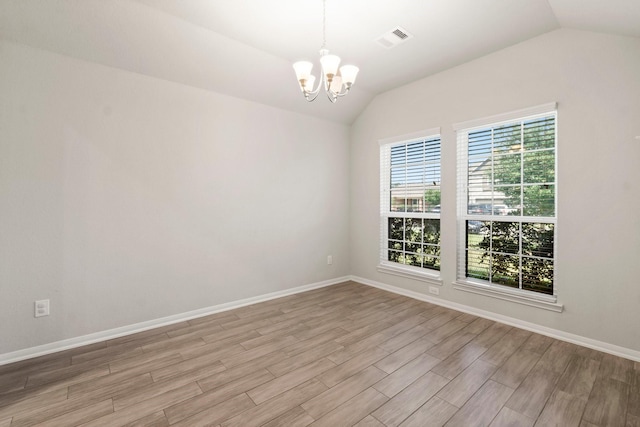 15111 Raffia Leaves Way, Houston, TX 77090 - spare room with vaulted ceiling, a chandelier, light wood finished floors, and baseboards