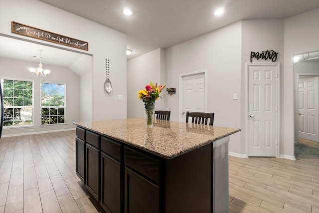 15111 Raffia Leaves Way, Houston, TX 77090 - kitchen with light wood-style floors, a center island, light stone countertops, baseboards, and recessed lighting