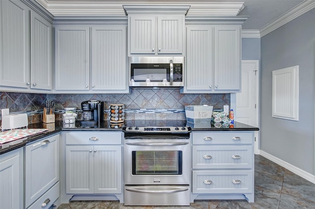 2774 Gulfview Ln, Crystal Beach, TX 77650 - kitchen featuring stainless steel appliances, crown molding, baseboards, tasteful backsplash, and dark stone counters