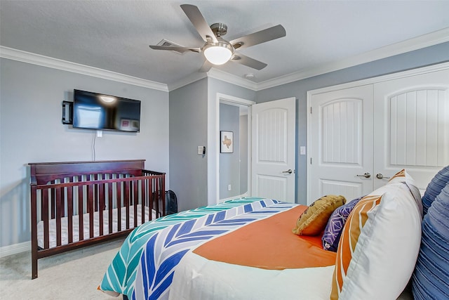 2774 Gulfview Ln, Crystal Beach, TX 77650 - bedroom featuring a closet, carpet floors, crown molding, ceiling fan, and baseboards