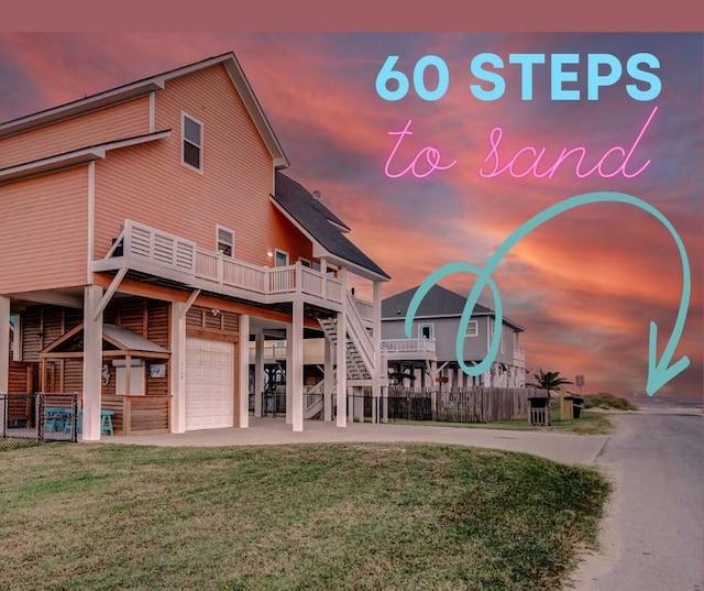 2774 Gulfview Ln, Crystal Beach, TX 77650 - rear view of property with a garage, a wooden deck, stairway, and driveway