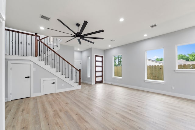 6631 Foster St, Houston, TX 77021 - unfurnished living room featuring light wood-style flooring, recessed lighting, stairway, baseboards, and ceiling fan