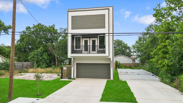 6631 Foster St, Houston, TX 77021 - modern home with a balcony, concrete driveway, a garage, stairway, and french doors