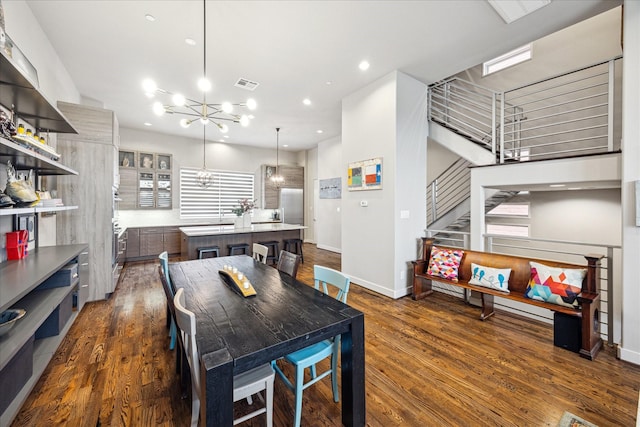 2707 Rusk St, Houston, TX 77003 - dining space featuring a chandelier, dark wood-style floors, stairway, baseboards, and recessed lighting
