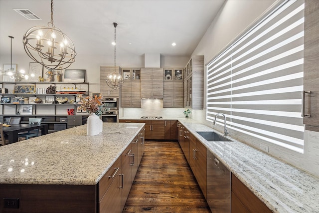 2707 Rusk St, Houston, TX 77003 - kitchen with a sink, a spacious island, a chandelier, light stone counters, and stainless steel appliances