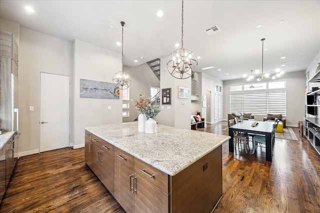 2707 Rusk St, Houston, TX 77003 - kitchen featuring a chandelier, a center island, dark wood-type flooring, open floor plan, and recessed lighting