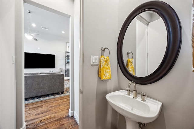 2707 Rusk St, Houston, TX 77003 - bathroom with wood finished floors, a ceiling fan, a sink, and baseboards